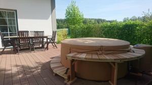 a patio with a table and chairs on a patio at Villa Loch Nr.5 in Litschau