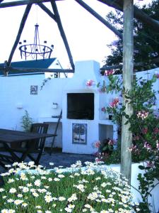 a house with a fireplace and flowers in a yard at Kingston Farm in Bathurst