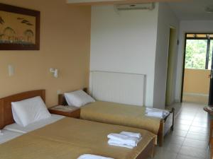 a room with two beds and a window at Asteri Studios in Skiathos Town
