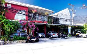 a group of motorcycles parked in front of a building at Phuket Paradiso in Chalong 