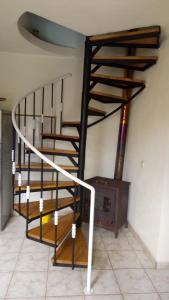 a spiral staircase in a room with a fireplace at Casa Reis in Santana