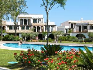 a swimming pool in front of a house at Lirio in L'Ampolla +12 photos