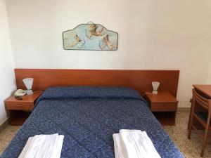 Voodi või voodid majutusasutuse Hotel Villa San Giovanni toas