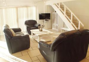 a living room with two chairs and a table at Point Village Accommodation - Hennie Bottom in Mossel Bay