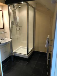 a bathroom with a shower and a sink at The Crown Inn in Lanlivery