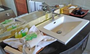 a bathroom with a sink and a counter with towels at Starsand Beach Resort in Sekotong +66 photos
