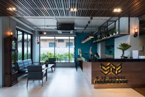 a lobby of a hotel with a bar and chairs at S.22 Hotel Suratthani in Surat Thani