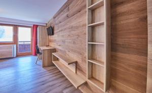 a room with a wooden wall with shelves at Appartements Gappmaier in Saalbach Hinterglemm