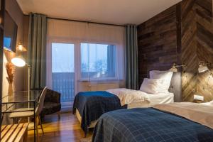 Un pat sau paturi într-o cameră la Pensiunea Belvedere