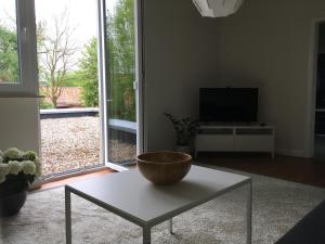 a living room with a table and a large window at Apothekerwohnung in Friesoythe