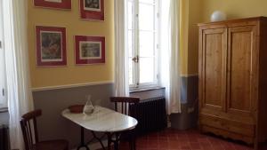 Sallèles-dʼAudeにあるLa Maison du Docteurの窓付きの客室で、小さなテーブルと椅子が備わります。