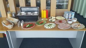 a table with plates of food on top at Sea Hostel in Gdynia +60 photos