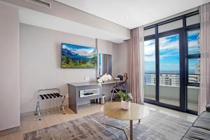 a living room with a desk and a window at The Capital Pearls Hotel in Durban