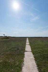 a path in the middle of a field at #Luxlikehome - The Seascape Villa in Skála Foúrkas
