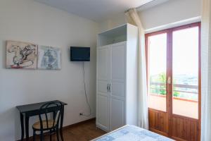a bedroom with a bed and a window and a table at B&B Terramare in Castorano