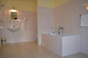 ein Badezimmer mit einem Waschbecken, einer Badewanne und einem WC in der Unterkunft Hotel U dvou zlatých klíčů in Prag