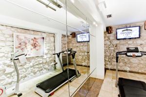 a gym with a treadmill and a glass wall at Hotel Senacki in Krakow