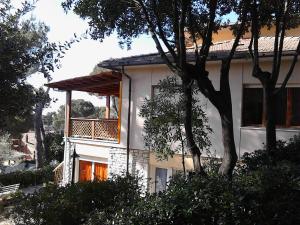 a house with a balcony on the side of it at La Casa di Ulisse B&B in Quercianella