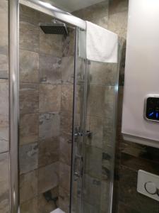 a shower with a glass door in a bathroom at Apartament Slavia Rosa in Międzyzdroje +43 photos
