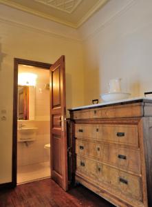 a bathroom with a wooden dresser with a sink on top at Hydra Optima in Hydra