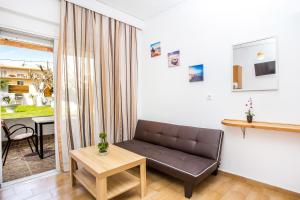 a living room with a couch and a table at Toulas Studios & Apts No2 in Faliraki