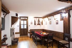 a dining room with a table and chairs at ЧОЛАКОВАТА КЪЩА in Koprivshtitsa