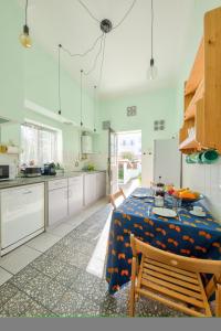 a kitchen with a table with a blue table cloth on it at The Beach House in Praia da Barra