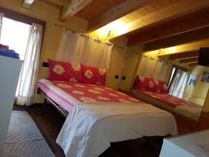 a small bedroom with a bed in a house at Dora Baltea Monolocale primo piano Mansarda secondo piano in Verona