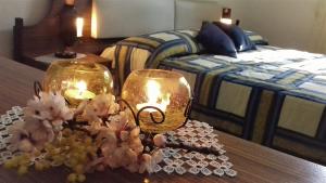 a bedroom with a table with two candles and a bed at Dedo B&B in Terlizzi