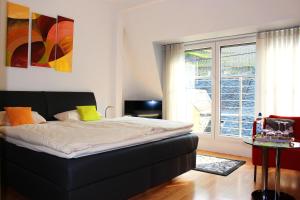 - une chambre avec un lit et une grande fenêtre dans l'établissement Pension Adelheid Moselhype&Wine, à Zell