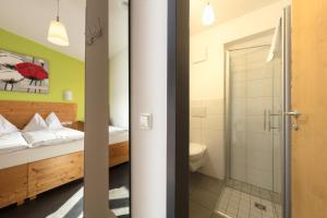 a bathroom with a bed and a shower and a toilet at Hotel Demling in Randersacker +128 photos