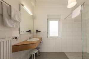 a bathroom with a sink and a mirror at Hotel-Cafe Demling in Randersacker