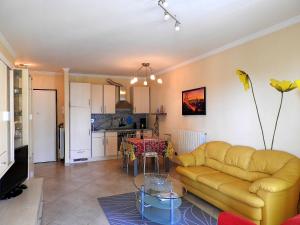 a living room and kitchen with a couch and a table at Villa Emma in Ospedaletti