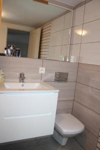 a bathroom with a sink and a toilet at Apartament u Marzenki in Augustów