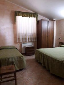 チェルヴェーテリにあるla Campagnolaのベッドルーム1室(ベッド2台、ドレッサー、窓付)
