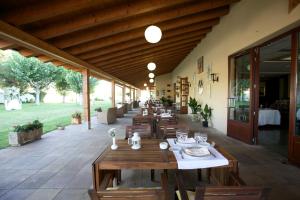 a restaurant with wooden tables and chairs on a patio at Hotel del Carme in Vilagrasa