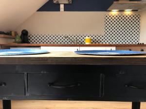 two blue plates on a counter in a kitchen at ★ Studio ★ Brive Centre ★ in Brive-la-Gaillarde