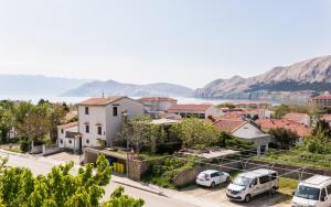 a city with cars parked in a parking lot at King's Apartment in Baška