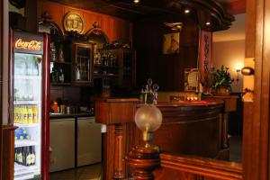 a kitchen with a bar and a refrigerator at Penzión Grand in Trnava