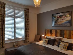 a bedroom with a large bed and a window at Beach Lodge in Bournemouth