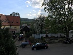 a car parked in a parking lot in a village at Ubytování u Hořejších na statku in Křemže