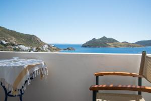 a table and two chairs on a balcony with the ocean at Captain Manos Studio Apartments in Grikos