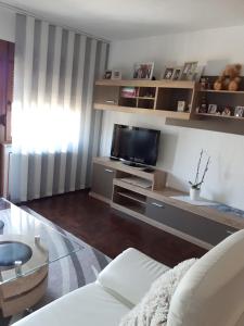 a living room with a couch and a tv at Apartman Petra & Tena in Slunj