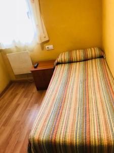 A bed or beds in a room at Pensión la Estación