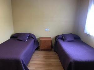 A bed or beds in a room at Pensión la Estación