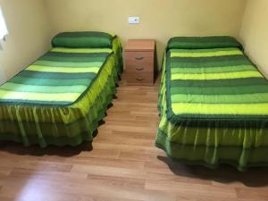 A bed or beds in a room at Pensión la Estación