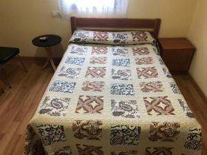 A bed or beds in a room at Pensión la Estación