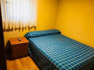 A bed or beds in a room at Pensión la Estación