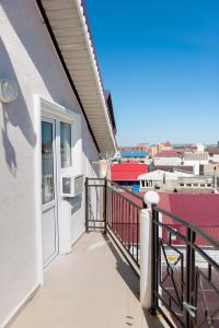 a balcony with a view of a city at Malenkaya Greсia in Anapa