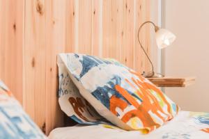 a pillow sitting on top of a bed with a lamp at Casa Azul da Beija in Furnas